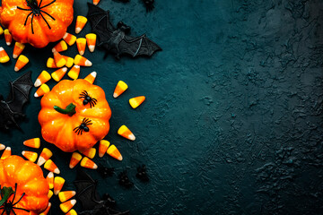 Happy Halloween blue background with pumpkins, bats, spiders and candy corn. Frame border with copy space