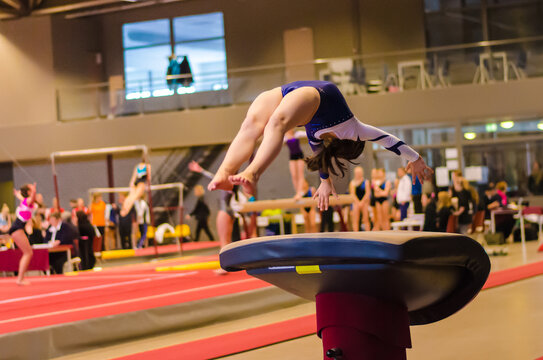 Young gymnast girl performing jump