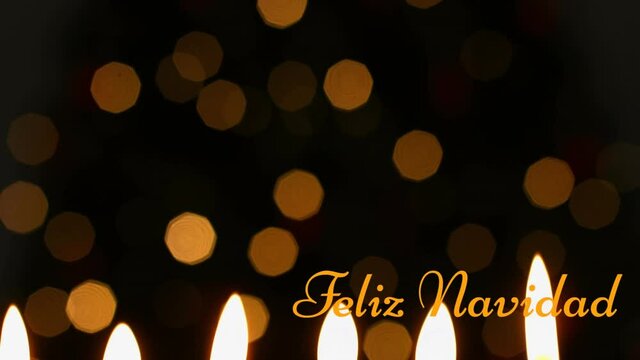 Animation of feliz navidad text over candles
