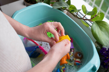 Washing plastic kids toys from microbes and dirt