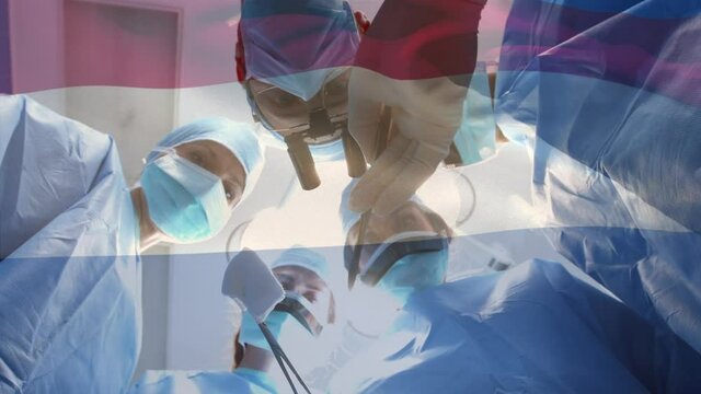 Animation of flag of netherlands waving over surgeons in operating theatre