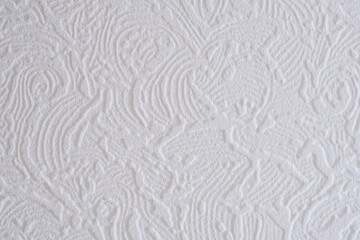 Close-up of a white ribbed pattern on a ceiling tile.