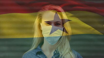 Animation of flag of ghana waving over woman wearing face mask during covid 19 pandemic - Powered by Adobe