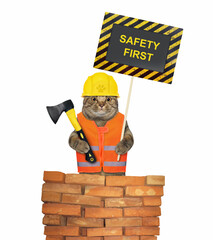 A beige cat in a construction helmet holds an axe and a poster that says safety first. White background. Isolated.