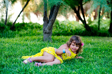 Naklejka na ściany i meble girl relaxing in the grass