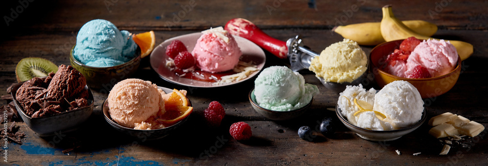 Poster Panoramic view of an assortment of ice cream balls on a wooden table