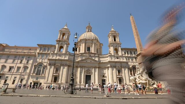 Sant'Agnese in Agone. Tourists near Fountain of the Four Rivers on Piazza Navona in Rome Italy