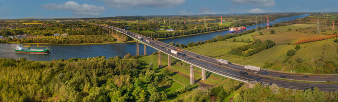 Cargo ships and motorway bridge. The Rader Hochbr&uuml;cke crosses the A 7 federal motorway between the Rendsburg/B&uuml;delsdorf junction and the Rendsburg interchange via Kiel Canal and "Borgstedter Enge".
