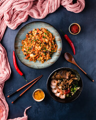 Traditional Chinese or Thai food set. Chinese noodles, fried rice with chicken, tom yum soup,deep fried fish and udon with shrimps. Asian style food concept.