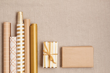 Christmas background with gift boxes and rolls of wrapping paper. Xmas celebration, preparation for...