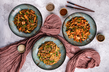 Asian food table with various kind of chinese noodles with chicken, pork, beef and others