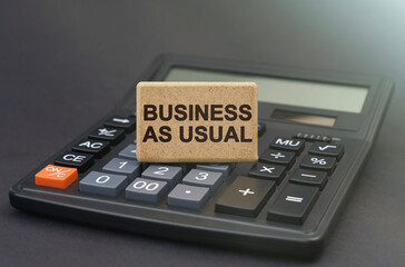 There is a sign on the calculator that says - Business as usual