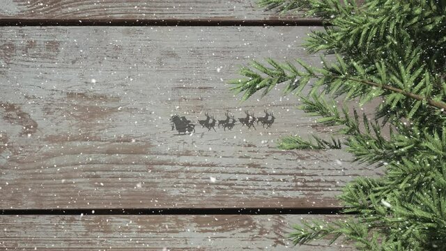 Tree branches and santa claus in sleigh being pulled by reindeers against wooden plank