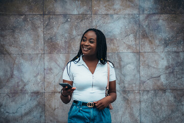 Beautiful african american woman using smartphone while out in the city