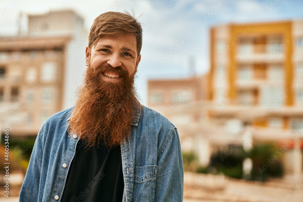 Sticker Young irish hipster man smiling happy standing at the city.