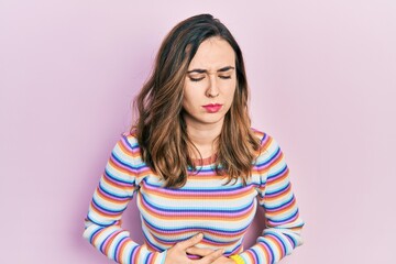 Young hispanic girl wearing casual clothes with hand on stomach because indigestion, painful...