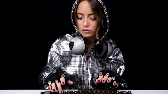 Woman with silver hoodie typing on keyboard