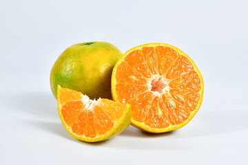 Fototapeta na wymiar Half of orange and the whole orange. On white background.