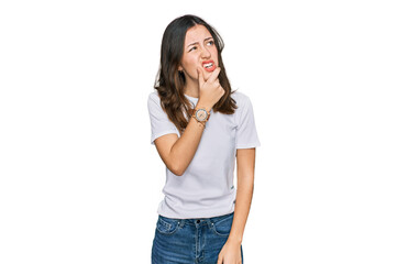 Fototapeta premium Young beautiful woman wearing casual white t shirt thinking worried about a question, concerned and nervous with hand on chin
