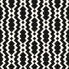 Seamless geo ethnic pattern. Illustration with black and white zigzag shapes, lines. Vector background is used in the design of carpets, textiles, clothing, wallpaper, cover, packaging