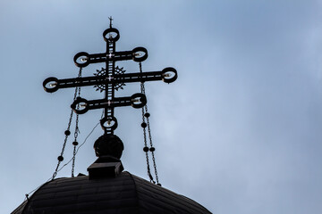 Christian Orthodox cross on top of a Romanian church's central tower.