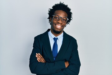 Young african american man wearing business suit happy face smiling with crossed arms looking at the camera. positive person.