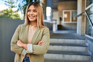 Young latin woman smiling confident at street