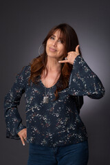 portrait of a woman, call me hand signal