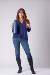 woman drinking mate, holding a termo