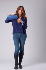 woman drinking mate, holding a termo