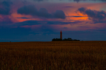 Lighthouse behind a cornfield at sunset. Germany, Island Fehmarn