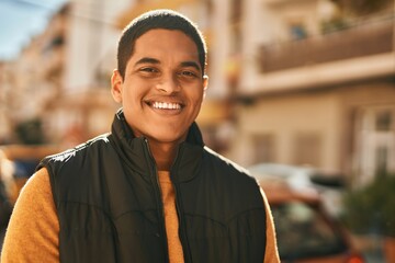 Fototapeta premium Young latin man smiling happy standing at the city