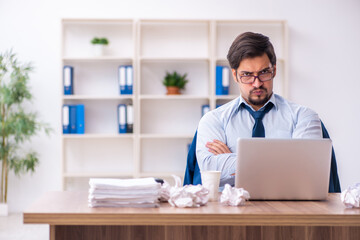 Young male employee rejecting new ideas in the office