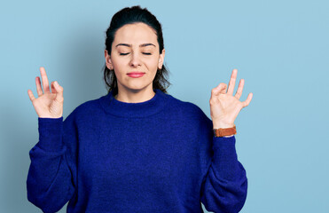 Fototapeta premium Young hispanic woman wearing casual clothes relaxed and smiling with eyes closed doing meditation gesture with fingers. yoga concept.