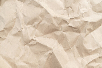 Recycled brown creased paper background from a paper packing. Crumpled brown paper texture concept