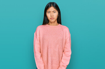 Fototapeta premium Beautiful young asian woman wearing casual winter sweater depressed and worry for distress, crying angry and afraid. sad expression.