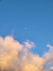 Close up photo of sky with clouds and the moon 