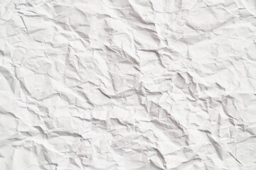 White crumpled paper texture with wrinkles. Damaged and torn sheet