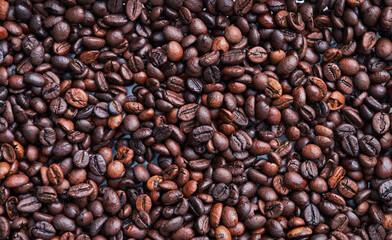 Brown and black coffee beans. Roasted arabic espresso coffee grains.
