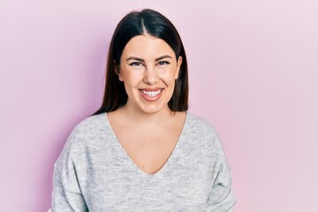 Fototapeta premium Young hispanic woman wearing casual clothes with a happy and cool smile on face. lucky person.