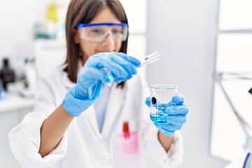 Young hispanic girl working at laboratory