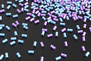 Large group of batteries on a black background. 3d render illustration.