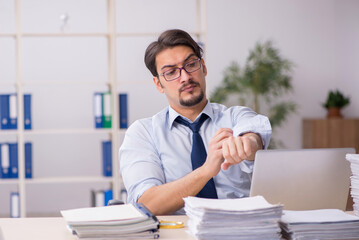 Young businessman employee unhappy with excessive work in the of