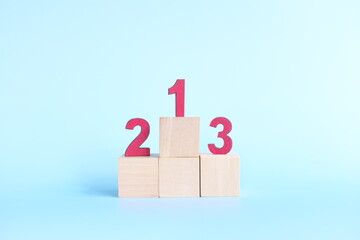 Podium, ranking and hierarchy concept. Wooden blocks with numbers 123 in blue background.