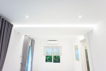 LED strip or ribbon light suspended on ceiling in empty living room include white wall, window,...