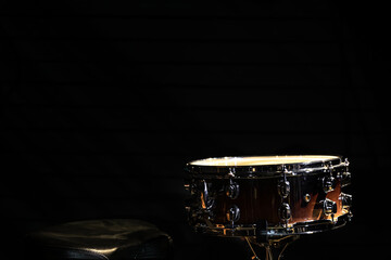 Fototapeta na wymiar Snare drum on a black background, copy space.