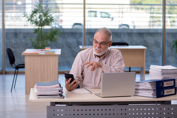 Old male bookkeeper in budget planning concept