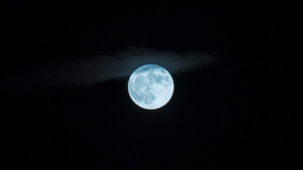 Naklejka na ściany i meble Moon shining through the clouds