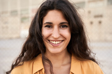 Cute young woman looking at camera. Smiling happy people.