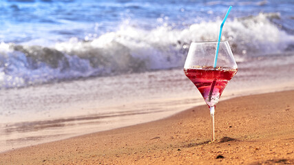 Wine glass with a cocktail by the sea.